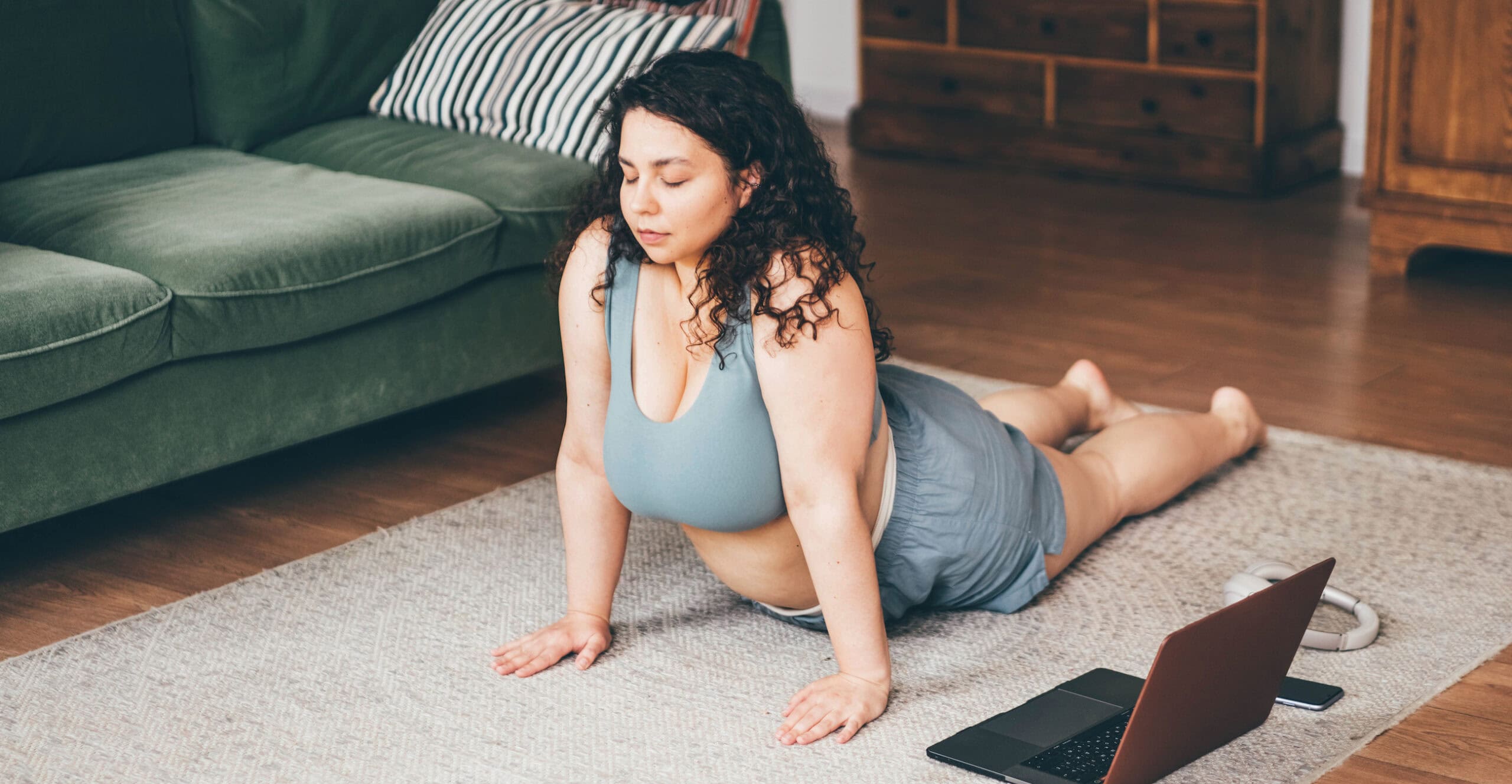 Plus size woman doing yoga and meditation at home.