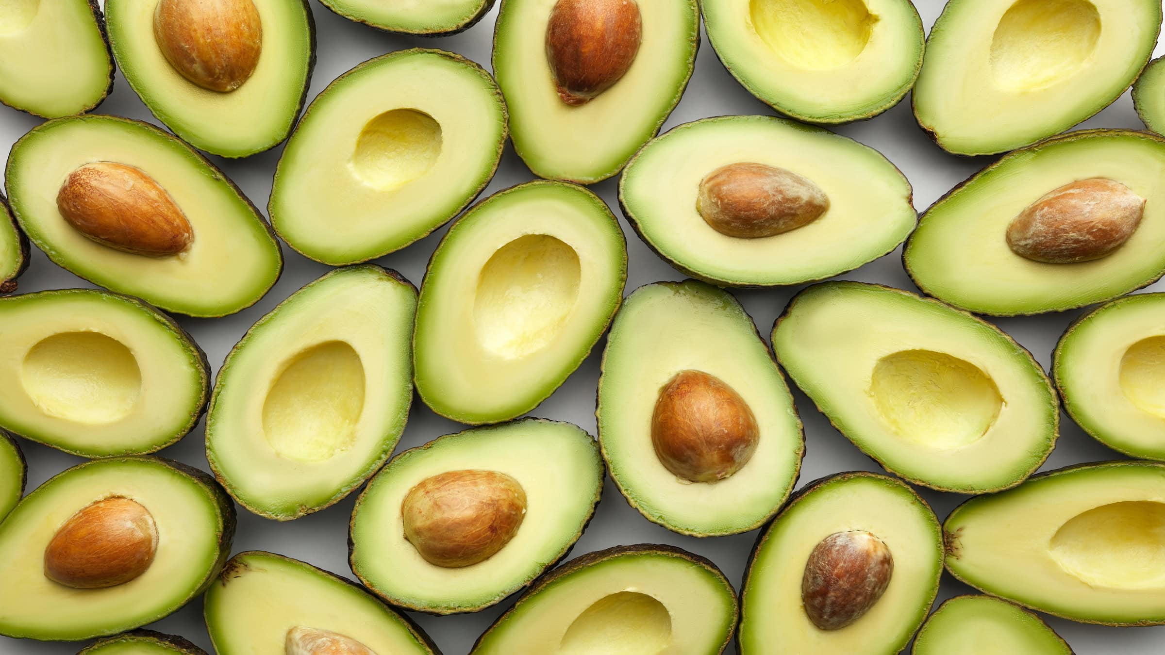 Close-up above view of sliced fresh avocado fruits.