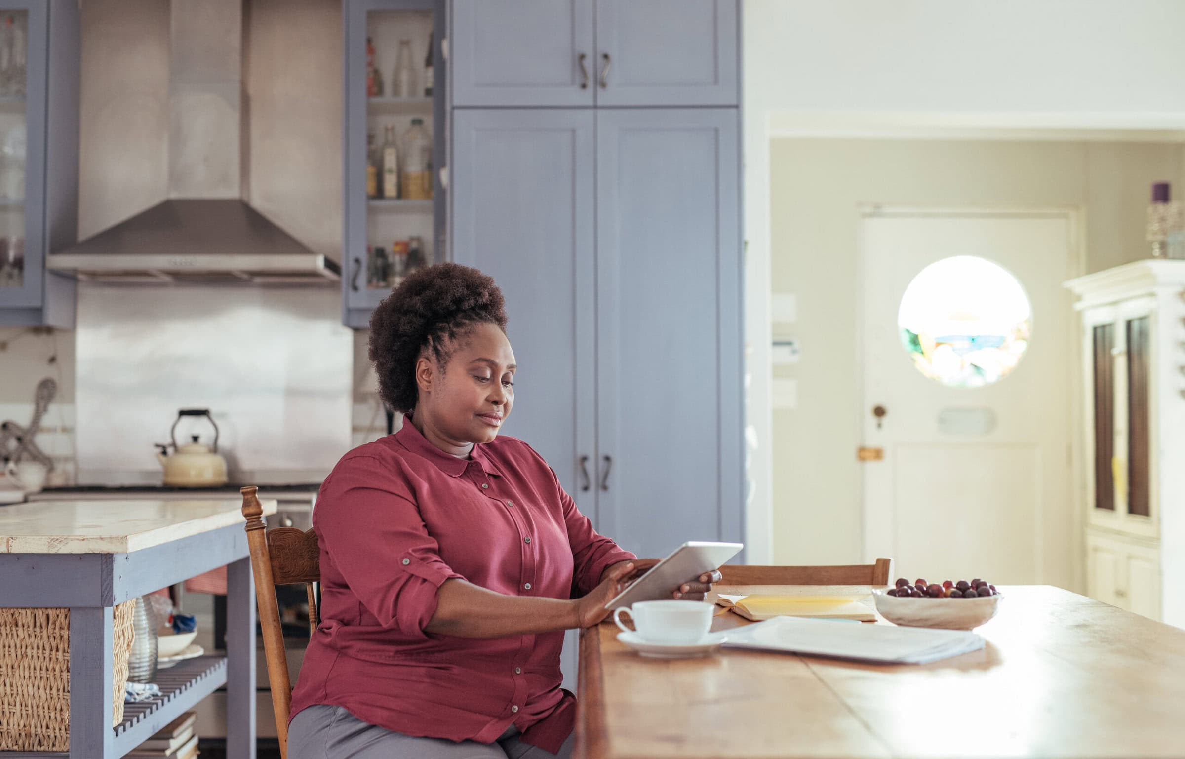 Young,African,Woman,Sitting,Alone,At,Her,Kitchen,Table,At
